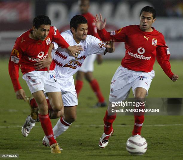 Mohammed Barakat and Ahmed Fathi of al-Ahly vie for the ball with Zamalek's Mohammed Abu Alaa during their football match in Cairo on March 14, 2008....