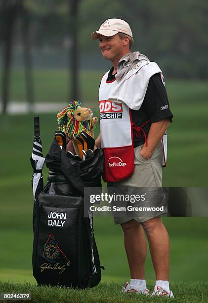 Head coach Jon Gruden of the Tampa Bay Buccaneers caddies for John Daly during the first round of the PODS Championship at Innisbrook Resort and Golf...