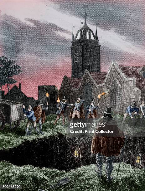 Filling a mass grave at night during the Plague of London, c 1665. Showing a group of men with torches in a churchyard, preparing to empty the...