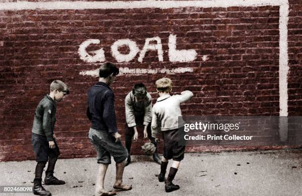 Football in the East End, London, 1926-1927. Illustration from Wonderful London, edited by Arthur St John Adcock, Volume I, published by Amalgamated...