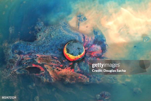 high angle view of a disolving bath bomb in the bath water - bath bomb stock pictures, royalty-free photos & images