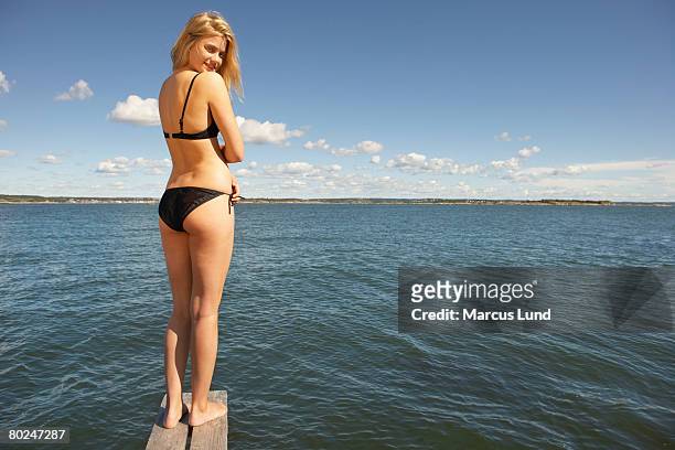 young woman on diving platform. - woman diving board stock pictures, royalty-free photos & images