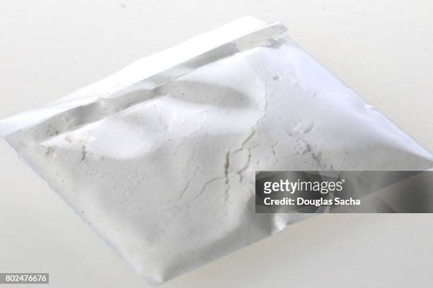 individual bag of illegal drug on a white background - crack cocaine fotografías e imágenes de stock