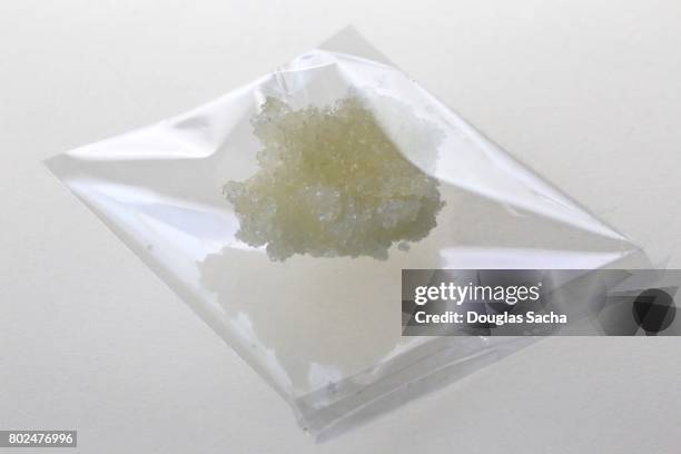 individual bag of illegal street drug on a white background - methamphetamine stock pictures, royalty-free photos & images