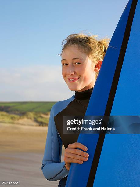 portrait of a brunette female surfer. - croyde beach stock pictures, royalty-free photos & images