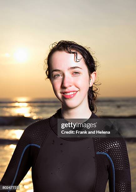 portrait of a brunette female surfer. - croyde beach stock pictures, royalty-free photos & images