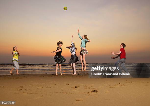 five teenagers playing catch. - croyde beach stock pictures, royalty-free photos & images