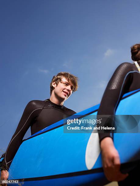 surfer wearing a wetsuit. - croyde beach stock pictures, royalty-free photos & images