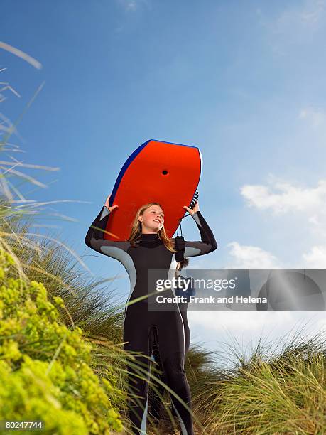 female wearing a wetsuit. - croyde beach stock pictures, royalty-free photos & images