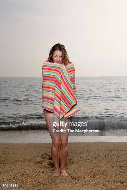 woman with a towel on the beach. - woman towel beach stock pictures, royalty-free photos & images