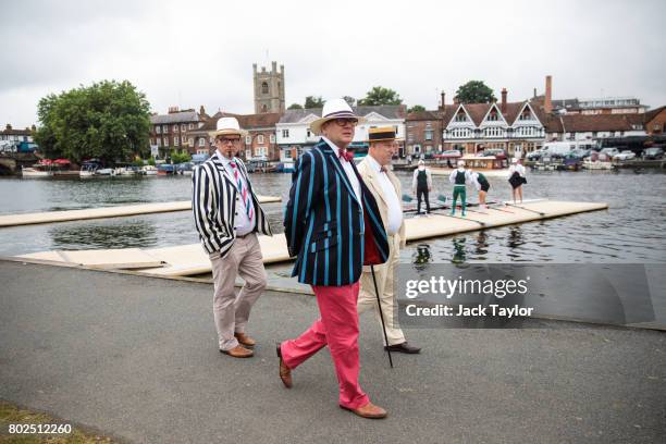 Spectators in boating blazers walk along the bank of the River Thames at the Henley Royal Regatta on June 28, 2017 in Henley-on-Thames, England. The...