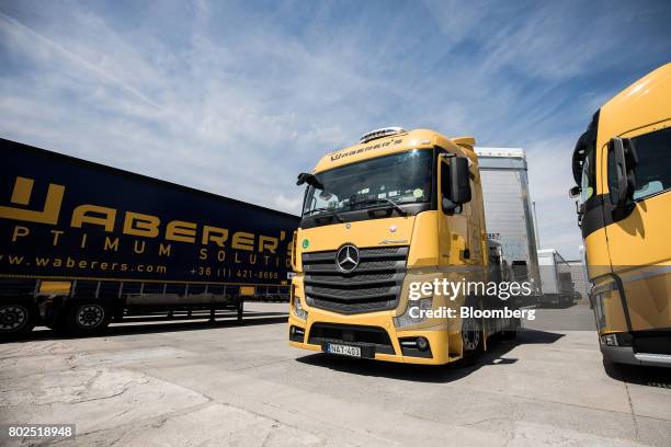 Waberers heavy goods truck drives through the parking area outside the Waberer's International Zrt. Headquarters in Budapest, Hungary, on Tuesday,...