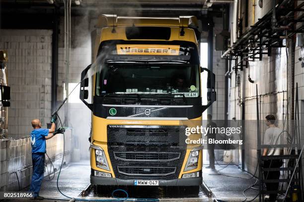 Workers clean a Waberers heavy goods truck in the service area at the Waberer's International Zrt. Headquarters in Budapest, Hungary, on Tuesday,...