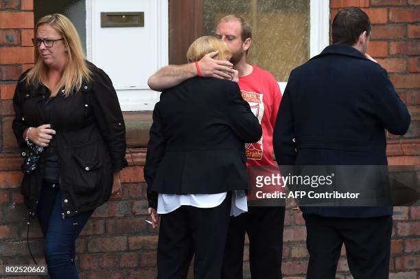 Family members, affected by the 1989 Hillsborough stadium disaster, comfort each other after being informed of the charging decisions by the...