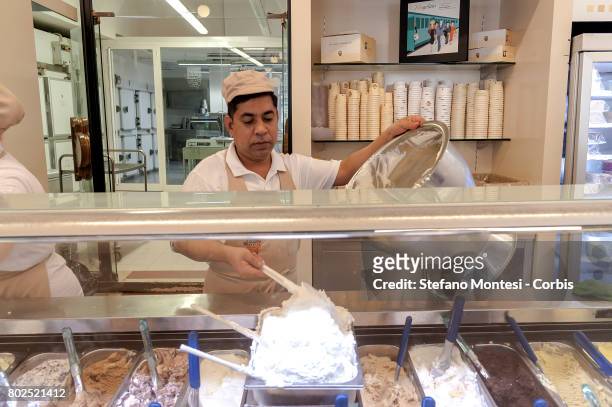 An employee scoops italian ice cream, at Palazzo del Freddo, means Palace of the Cold, di Giovanni Fassi is the oldest gelateria in Rome, from 1880....