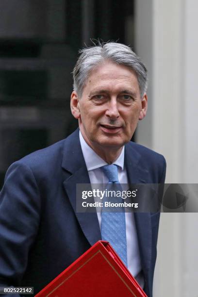 Philip Hammond, U.K. Chancellor of the exchequer, leaves 11 Downing Street on his way to attend the weekly question and answer session in Parliament...