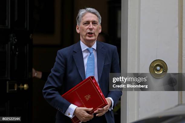 Philip Hammond, U.K. Chancellor of the exchequer, leaves 11 Downing Street on his way to attend the weekly question and answer session in Parliament...