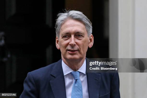 Philip Hammond, U.K. Chancellor of the exchequer, leaves 11 Downing Street on his way to attend the weekly question and answer session in Parliament...