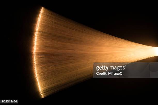 yellow colored fan shape fiber optics converging - amber stock pictures, royalty-free photos & images