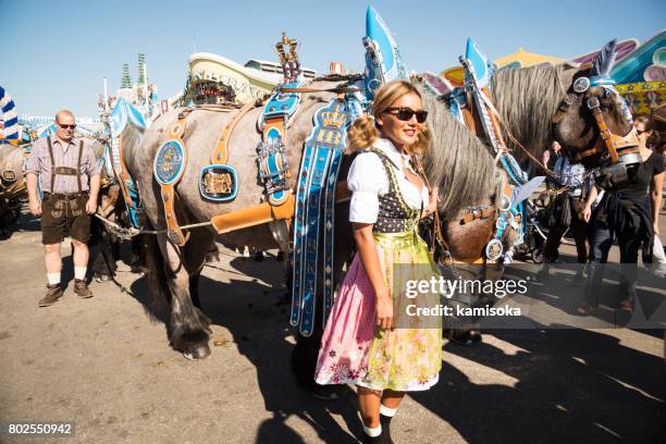 people posing in front of horses at the oktoberfest - bavaria flag stock pictures, royalty-free photos & images