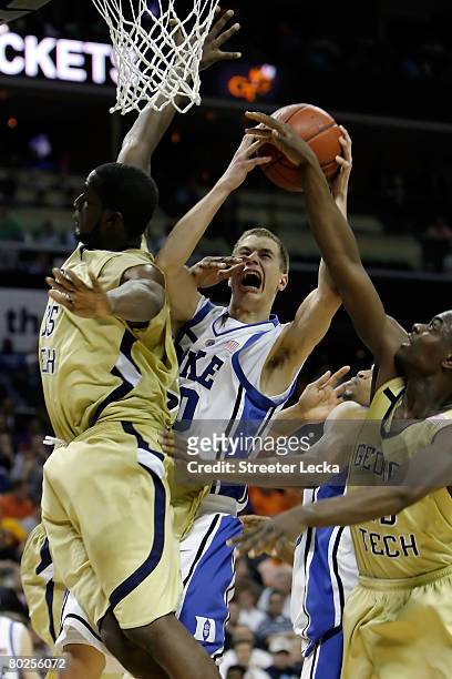 Jon Scheyer of the Duke Blue Devils goes up to shoot against Zack Peacock of the Georgia Tech Yellow Jackets during day two of the 2008 Men's ACC...