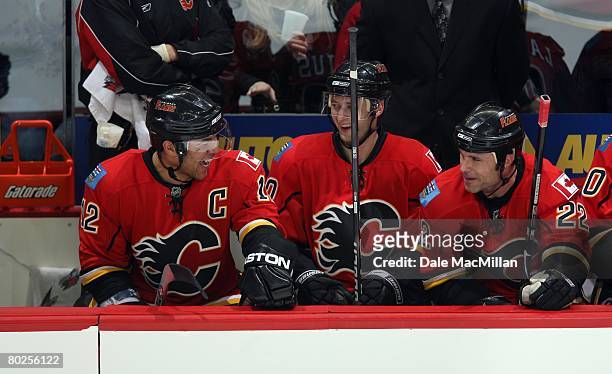 Jarome Iginla, Kristian Huselius and Daymond Langkow of the Calgary Flames have a laugh on the bench during their NHL game against the St. Louis...