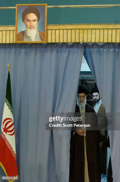 Iran's supreme religious leader Ayatollah Sayed Ali Khamenei steps out to cast his ballot in elections for the 8th "majlis" or parliament March 14,...