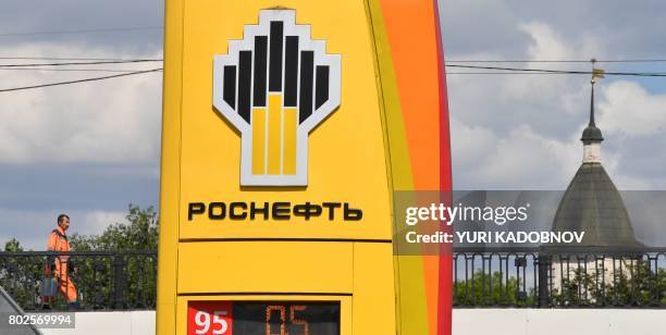 The company logo of Russia's state oil giant Rosneft is seen at a petrol station in Moscow on June 28, 2017. - A wave of cyberattacks hit Russia and...