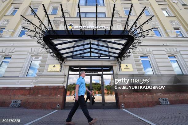 Man walks past the headquarters of Russia's state-controlled oil giant Rosneft in Moscow on June 28, 2017. - A wave of cyberattacks hit Russia and...