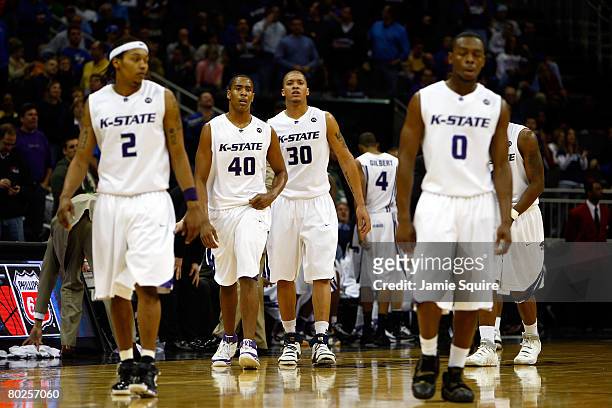 Michael Beasley and the Kansas State Wildcats walk back to the bench during a timeout in the game against the Texas A&M Aggies on day 2 of the Big 12...