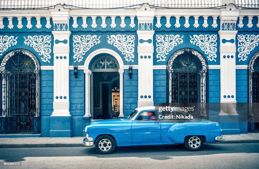 Old vintage car in front of colonial style house, Cuba