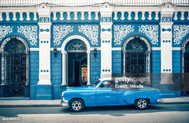 old vintage car in front of colonial style house, cuba - cuba car stock pictures, royalty-free photos & images