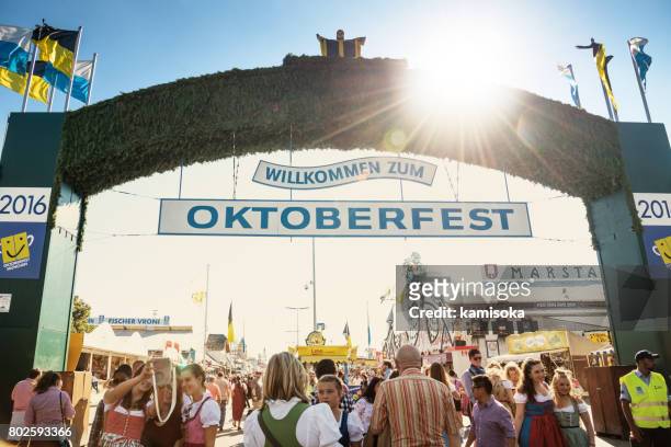 main entrance gate to oktoberfest fairground in munich, germany, 2016 - entrance sign stock pictures, royalty-free photos & images