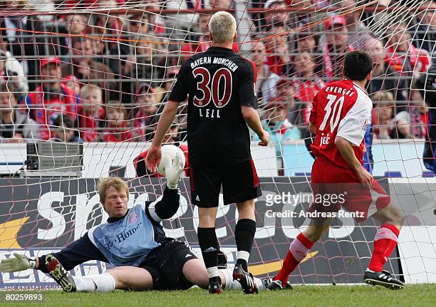 Branko Jelic of Cottbus scores the first goal as Goalkeeper Oliver Kahn and Christian Lell of Bayern Munich react during the Bundesliga match between...