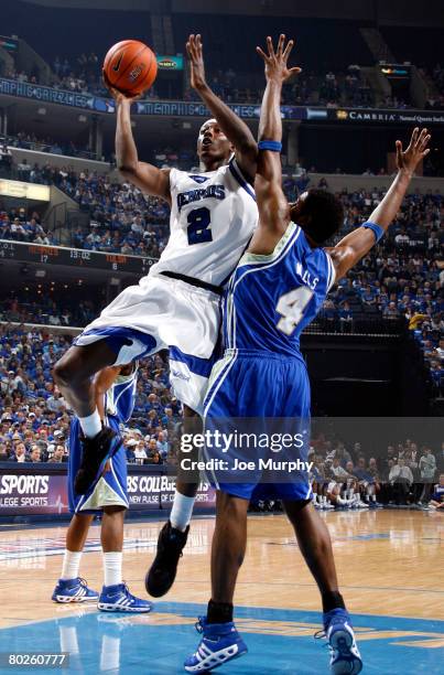 Robert Dozier of the Memphis Tigers shoots over Calvin Walls of the Tulsa Golden Hurricane during the finals of the Conference USA Basketball...