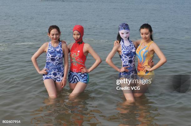 Model models the seventh version of facekini on a beach on June 28, 2017 in Qingdao, Shandong Province of China. The seventh version of facekini...