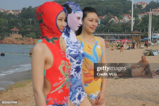 Model models the seventh version of facekini on a beach on June 28, 2017 in Qingdao, Shandong Province of China. The seventh version of facekini...