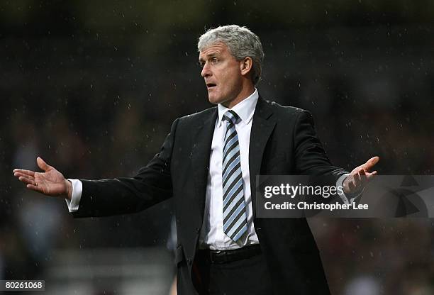 Manager Mark Hughes of Blackburn gestures to his players during the Barclays Premier League match between West Ham United and Blackburn Rovers at...