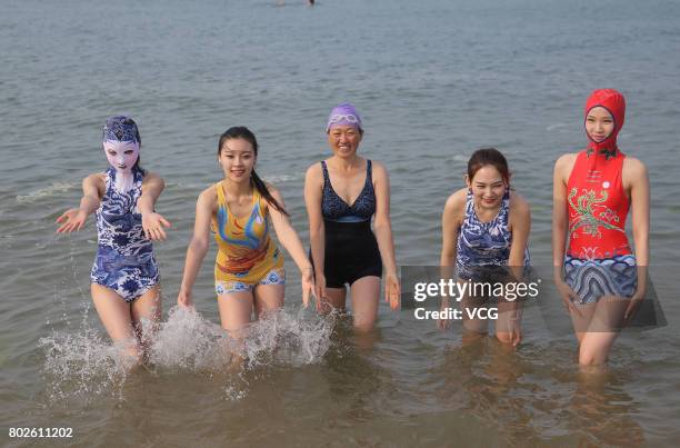 Model models the seventh version of facekini on a beach on June 28, 2017 in Qingdao, Shandong Province of China. The seventh version of facekini...