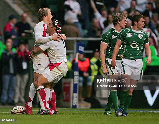 England's Left Wing, Lesley and Centre Matthew Tait celebrate Tait's try during their Six Nations Rugby Union Championship match against Ireland at...