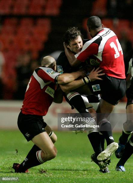 Ryan Knakowski of the Sharks is tackled by Jaco Pretorius & Waylon Murray of the Lions during the Super 14 match between Lions and Sharks held at...