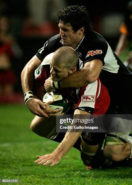 Ryan Kankoswki of the Sharks makes a try saving tackle on Jaco Pretorius of the Lions during the Super 14 match between Lions and Sharks held at...