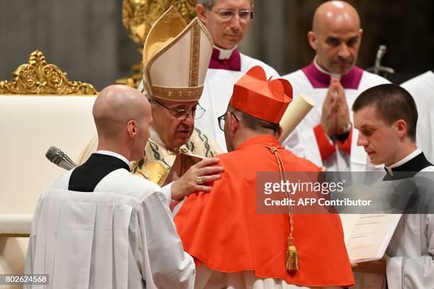 Archbishop of Barcelona Juan José Omella of Spain kneels before Pope Francis to pledge allegiance and become cardinal during a consistory for the...