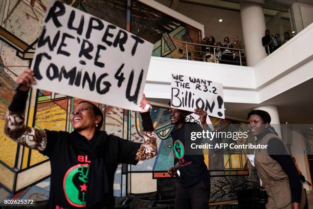 Placard with a slogan against Johann Rupert, the heir of South African business tycoon Anton Rupert, the chairman of the Swiss-based luxury-goods...