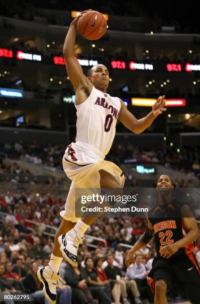 Jerryd Bayless of the Arizona Wildcats dunks over the defense of Calvin Haynes of the Oregon State Beavers during the 2008 Pacific Life Pac-10 Men's...