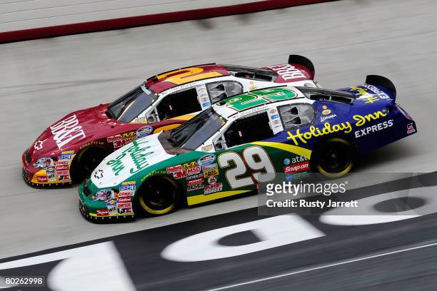Clint Bowyer , driver of the BB&T Chevrolet, races Scott Wimmer, driver of the Holiday Inn Chevrolet, side by side during the NASCAR Nationwide...