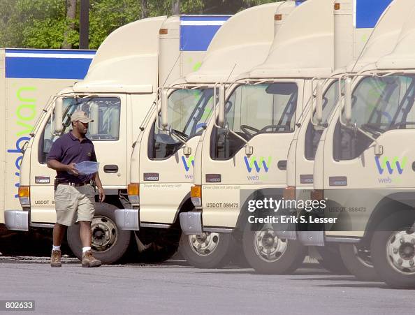 Webvan Owner A WebVan employee cleans out some of the company's trucks outside its ...