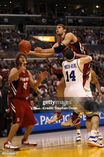 Brook Lopez of the Stanford Cardinal drives to the basket against the defense of Lorenzo Mata-Real of the UCLA Bruins during the championship game of...