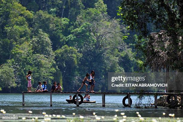 Children play in a jetty in Rio Dulce, some 250 km northeast of Guatemala City on March 15, 2008. Some 400 police and soldiers were searching...