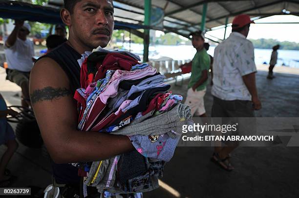 Man sells t-shirts in in Rio Dulce, some 250 km northeast of Guatemala City on March 15, 2008. Some 400 police and soldiers were searching northeast...
